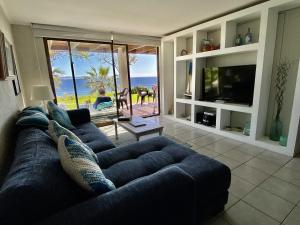 a blue couch in a living room with a view of the ocean at Puerto Velero/ Primera Linea in Puerto Velero