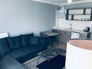 a living room with a couch and a kitchen at 06ev Rental House in Ankara