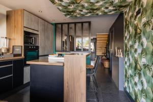 an open kitchen with a counter and a dining room at Chambre D'hôtes Chez Dom in Saint-Jean-de-Maurienne