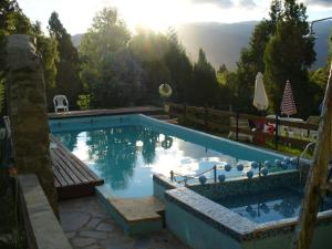 a swimming pool with a view of the mountains at Cabañas del Faldeo Titos in El Bolsón +60 photos