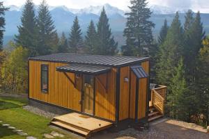 a tiny house with a solar roof on top of it at Golden Tiny Homes in Golden