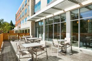 un patio con mesas y sillas frente a un edificio en Holiday Inn Express & Suites Salisbury, an IHG Hotel en Salisbury