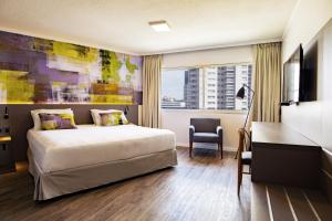 Ένα ή περισσότερα κρεβάτια σε δωμάτιο στο Palladium Business Hotel