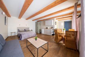 a living room with a bed and a table at Enjoy Old Town vibes in 1716 Laipu Residence with 4 stylish Apartments and 1 Penthouse in Riga