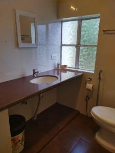 a bathroom with a sink and a toilet at Casa Encanto Homestay in Shillong