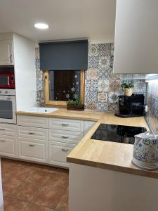 a kitchen with white cabinets and a counter top at Chata 1-Padesátka in Bedřichov