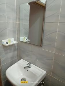 a bathroom with a sink and a mirror at Homestay Berkat D'sawah Tasek Berangan Pasir Mas in Pasir Mas