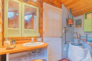 a bathroom with a sink and a toilet in a house at Private Cabin With Alaskan Charm in Fairbanks