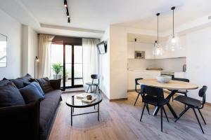 uma sala de estar com um sofá e uma mesa em Apartamento Bguest con terraza em Alicante