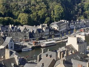 an aerial view of a town with a river and houses at L' atelier du 26 in Dinan
