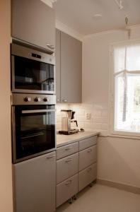 a kitchen with a stainless steel oven and a window at Mansikkaniemen Lomakeskus in Rantasalmi +29 photos
