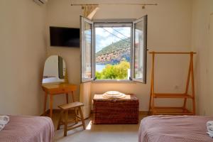 a bedroom with a window and a table and a mirror at Casa olive in Tolo