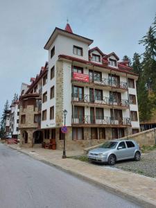 a building with a car parked in front of it at Комплекс Замъка 2 ап 301 in Pamporovo