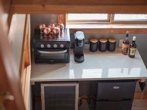 a kitchen counter with a stove and bottles of alcohol at Maple Ranch Golden in Golden