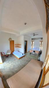 a large room with two beds and a table at Casa Mambo Salinas in Santa Veronica