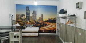 a bedroom with a city skyline mural on the wall at Aparsol Apartments in Madrid