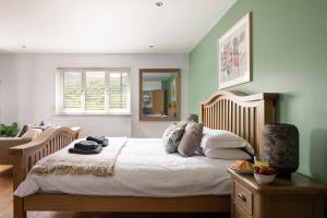 a bedroom with a large bed and a mirror at Arlyn, Padarn Lake Viewpoint in Snowdonia in Caernarfon