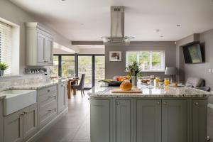 a kitchen with a large island with fruits on it at Arlyn, Padarn Lake Viewpoint in Snowdonia in Caernarfon