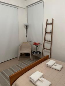 a room with a bed and a ladder and a chair at ARTEMIS 1 Bdr Down Town Nicosia in Nicosia +9 photos