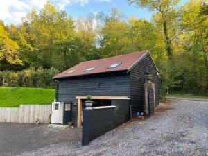 a black building with skylights on top of it at The Lodge in Royal Tunbridge Wells