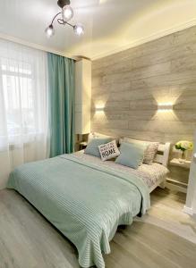 sypialnia z dużym łóżkiem i niebieskim kocem w obiekcie Tiffany Apartment w mieście Irpień