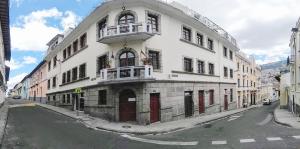a large white building on the side of a street at Vibes Aurik in Quito