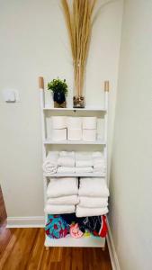 a stack of towels on a shelf in a room at Luxury 2/2 private oasis w/Hot Tub walk to Beach in Cape Canaveral