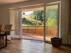 a room with a large sliding glass door to a balcony at kleineauszeit3, Feldberg, direkt an Skipiste, mit Sauna in Feldberg