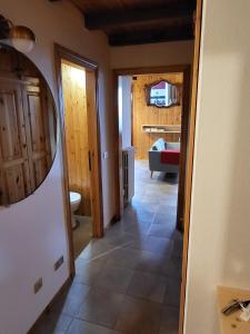 a hallway with a mirror in a room at Mansarda Abetone in Abetone