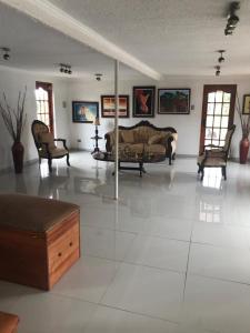 a large living room with a couch and chairs at HOTEL BOUTIQUE CASA BLANCA in Chillán