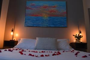 a bedroom with a bed with red roses on it at Bed and breakfast Villa Tota in Catanzaro Lido