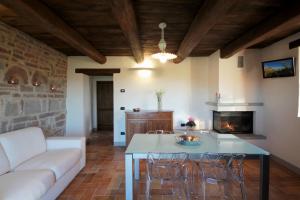 a living room with a table and a couch at Agriturismo Terrazza sul Parco in Bagno di Romagna