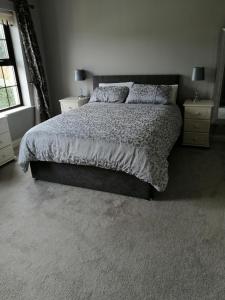 a bedroom with a large bed and a window at Clonoughter Heights in Glin
