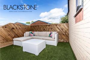 a patio with a white couch and a table at Avery House 4 - One Bedroom with Outdoor Terrace in Darlington
