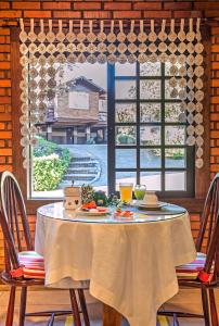 a table with a plate of food and a window at Hotel Canto Verde in Gramado +170 photos