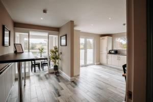 a kitchen and living room with a table and a dining room at Mountain View Lodge in Newcastle