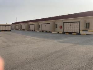 a row of garage doors in a parking lot at شاليهات ركـــام Recam For Holiday in Qarār