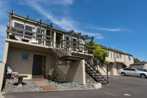 a building with a staircase on the side of it at Howick Motor Lodge in Auckland