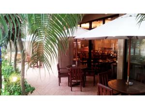 a restaurant with tables and chairs and a palm tree at Hotel Sun Queen - Vacation STAY 43433v in Naha