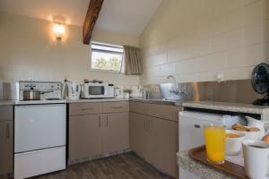 a kitchen with white appliances and a counter top at Howick Motor Lodge in Auckland