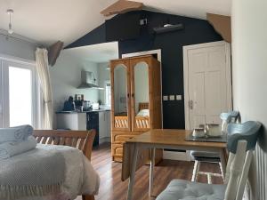 a living room with a table and a kitchen at Kingstown House in Cashel