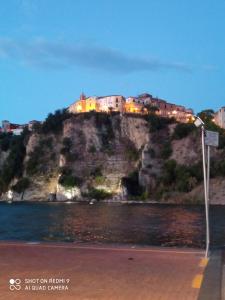 a town on top of a hill next to the water at Casa Vacanze Falco in Agropoli +5 photos