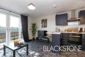 a kitchen with a black and white kitchen at Avery House 8 - One Bed Apartment by BPNE in Darlington
