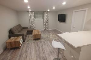 a living room with a couch and a table at Beautiful 2 bedroom + office basement suite in Calgary