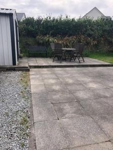 a picnic table and two benches on a patio at Skellig View in Portmagee