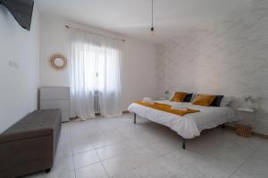 a white bedroom with a large bed and a window at Shiny Home Verona in Verona