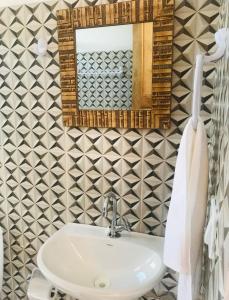 a bathroom with a sink and a mirror at Natal Chalés Nova Caraiva in Caraíva +85 photos