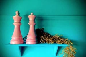 two chess pieces sitting on top of a table at 3 Bedroom House -Sleeps 6- Big Savings On Long Stays! in Canterbury
