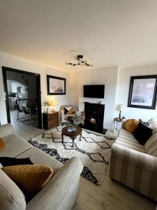 a living room with two couches and a fireplace at Elmwood House in Bangor