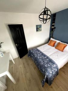 a bedroom with a bed and a chandelier at Elmwood House in Bangor